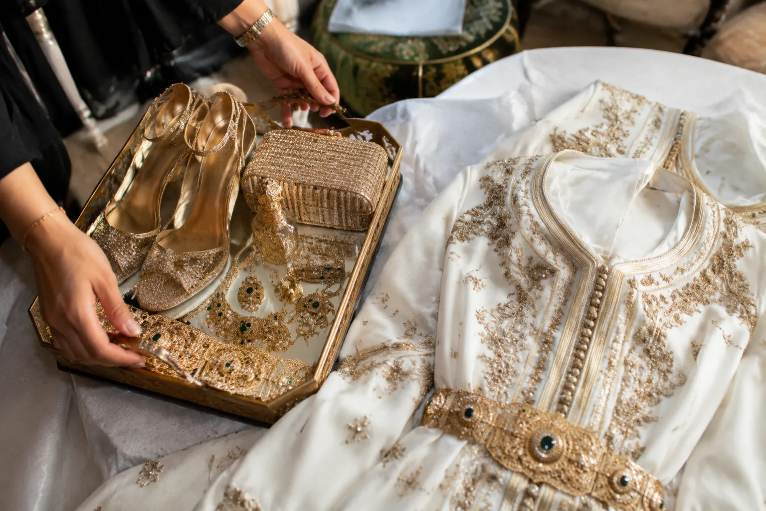 Coordinated Moroccan bridal accessory handoff prepared for an outfit change and entrance
