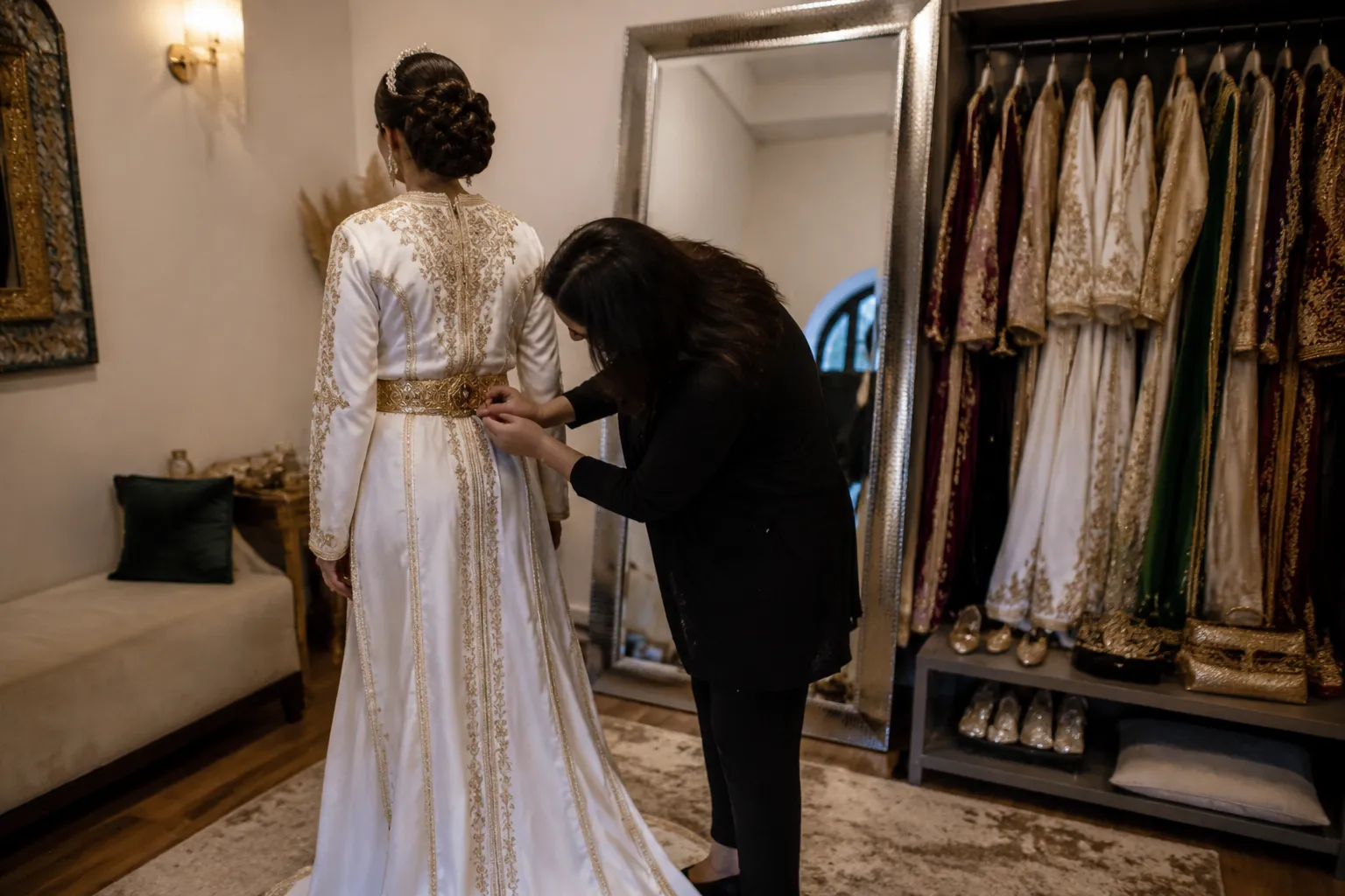 Bridal dresser checking a completed caftan look before re-entry